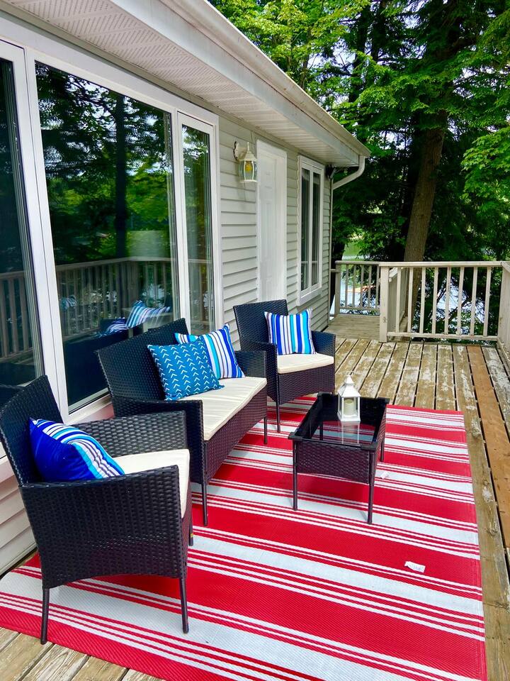 Waterfront firepit area with Adirondack chairs at dusk